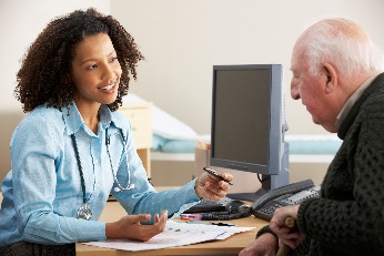 A doctor giving a man information.