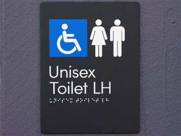 A sign with the disability symbol and unisex symbol. It has a Unisex Toilet LH sign and Braille underneath.