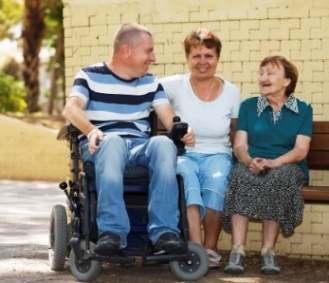 A man and 2 women are sitting together.