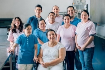 A large family visit one family member who is in hospital.