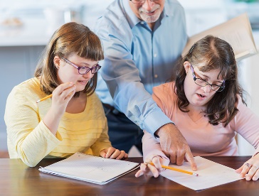 People with disability being instructed by a teacher.