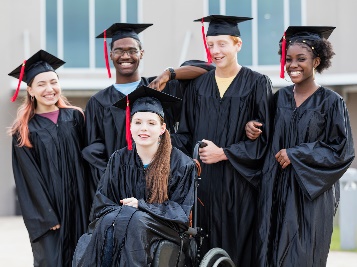 A group of students with disability wearing graduation caps and gowns.