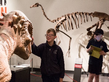 2 students viewing a dinosaur exhibit at the South Australia Mueseum.