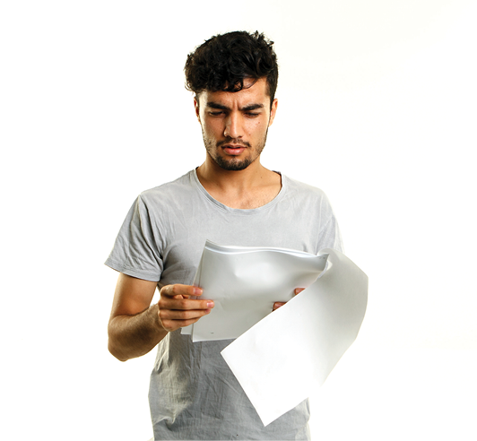 A man reading a document. He looks confused.