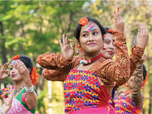 A group of people doing a cultural dance in traditional clothes.