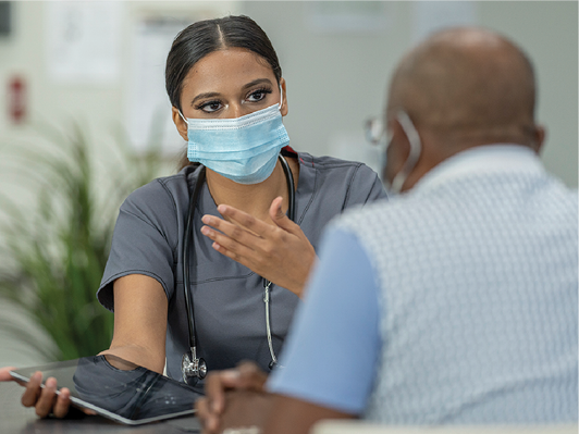 A doctor talking to someone in their office.