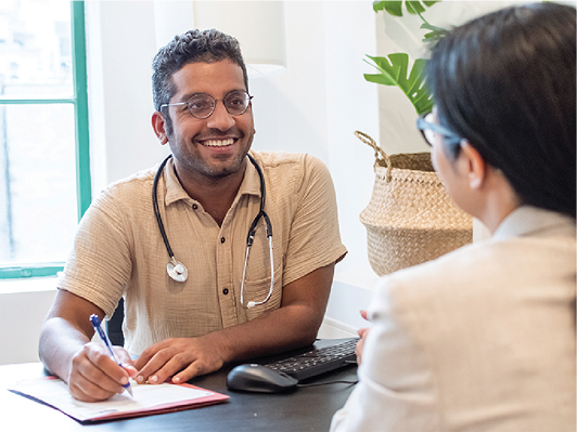 A doctor talking to someone in their office.