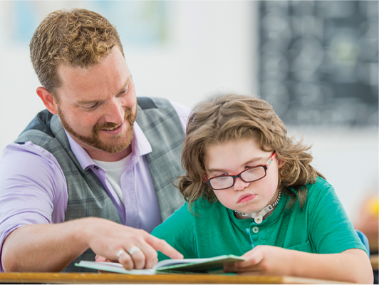 A teacher supporting an Autistic student.